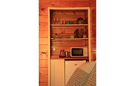 a small kitchenette in the room with microwave, fridge and tea/coffee making facilities